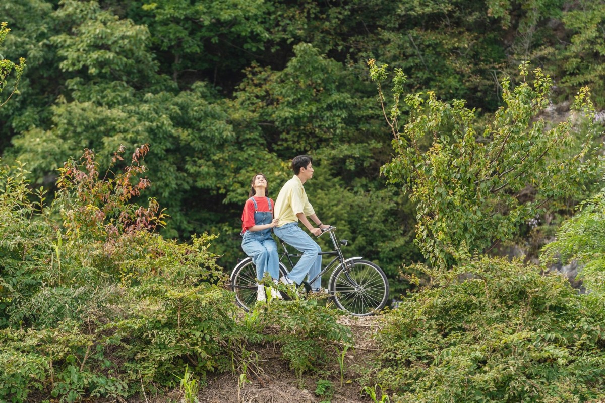 영화 '기적'의 한 장면. 박정민과 임윤아가 함께 자전거를 타는 장면은 강원도 정선 임계면 낙천리의 한 둑방 길에서 촬영했다. 사진 롯데엔터테인먼트